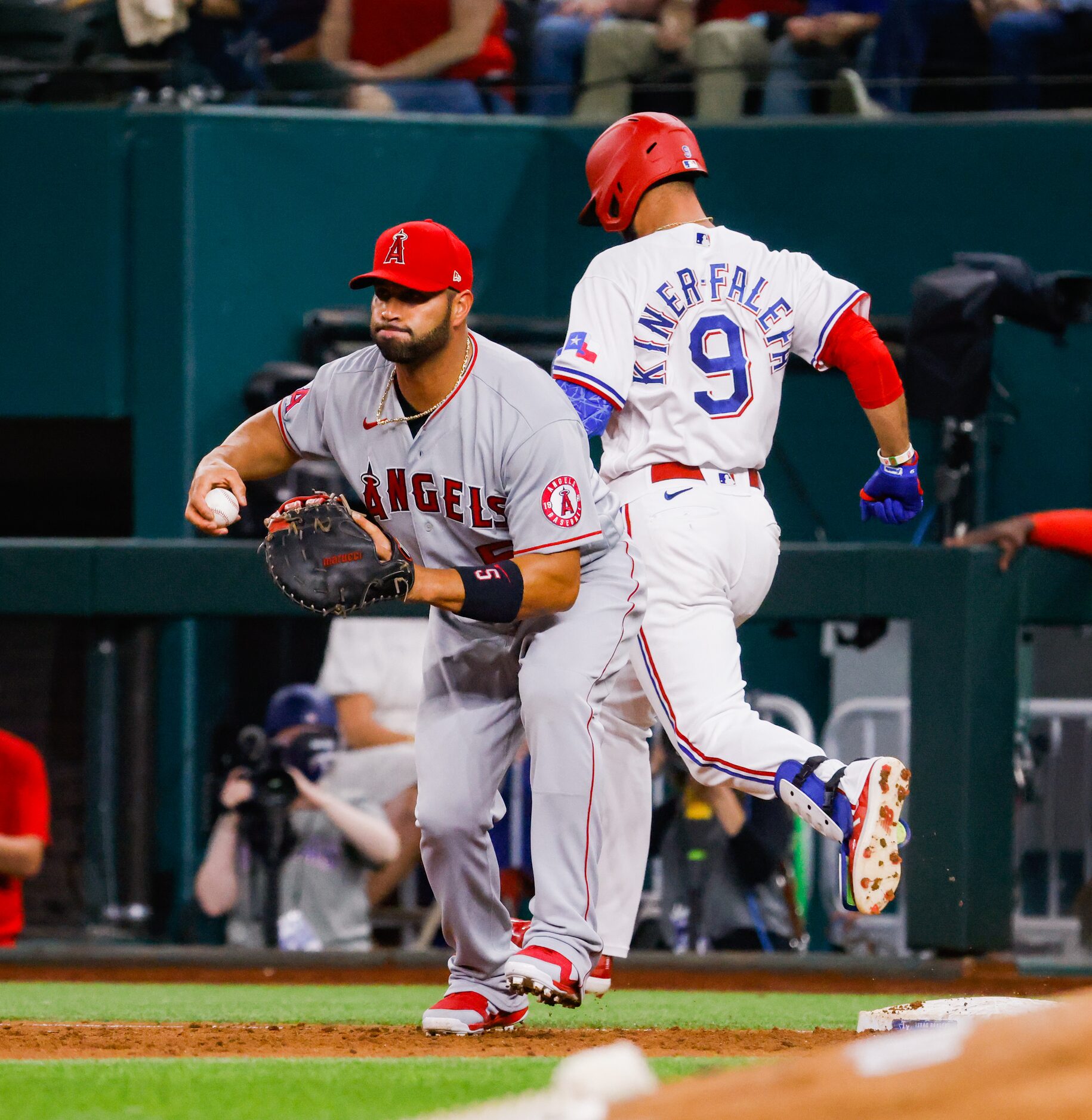 Texas Rangers third baseman Isiah Kiner-Falefa (9) is out by Los Angeles Angels first...