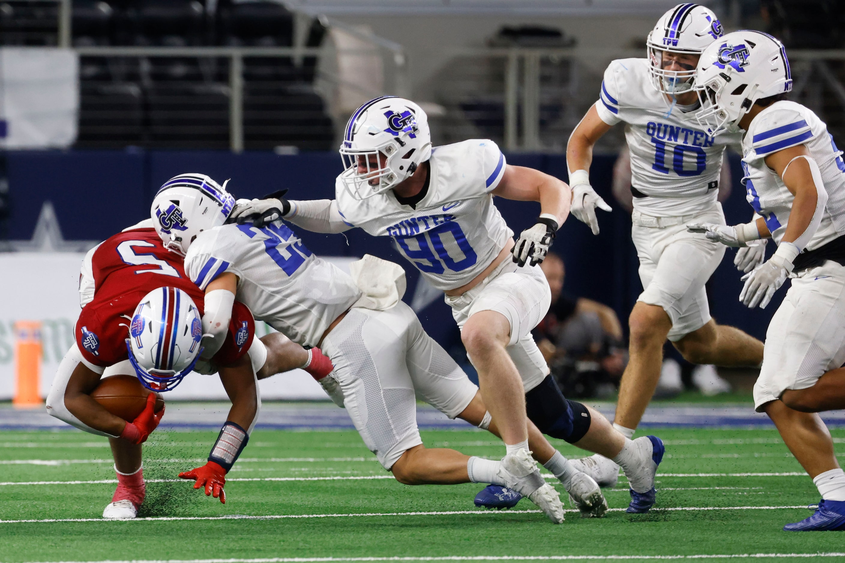 El Maton Tidehaven Joseph Dodds (left) is brought down by Gunter High’s Marshall Magers...