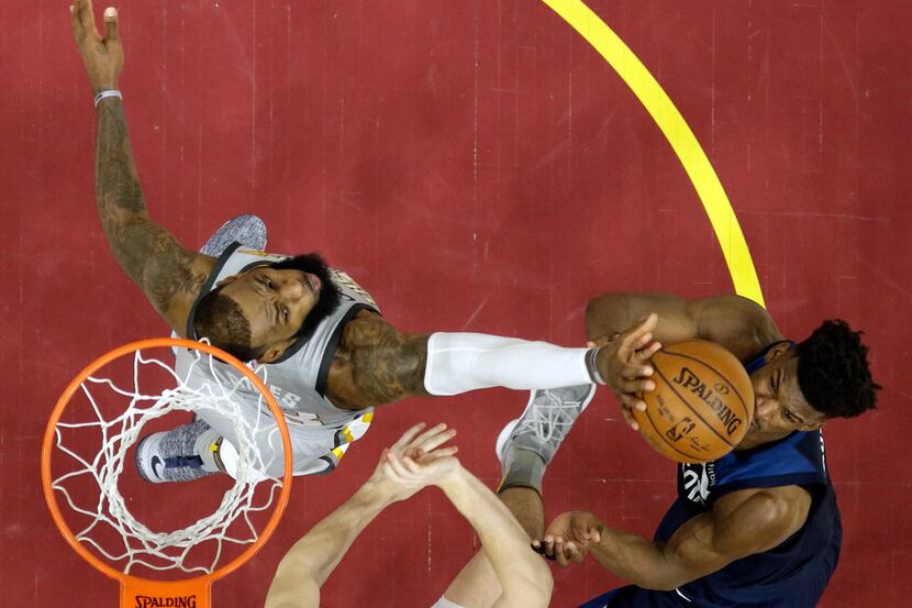 Cleveland Cavaliers' LeBron James, left, blocks a shot by Minnesota Timberwolves' Jimmy...