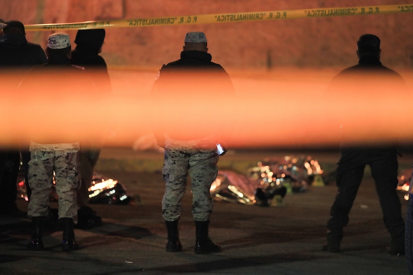 CD. JUAREZ Chih. Security forces stand amid the covered bodies at the site where more than...