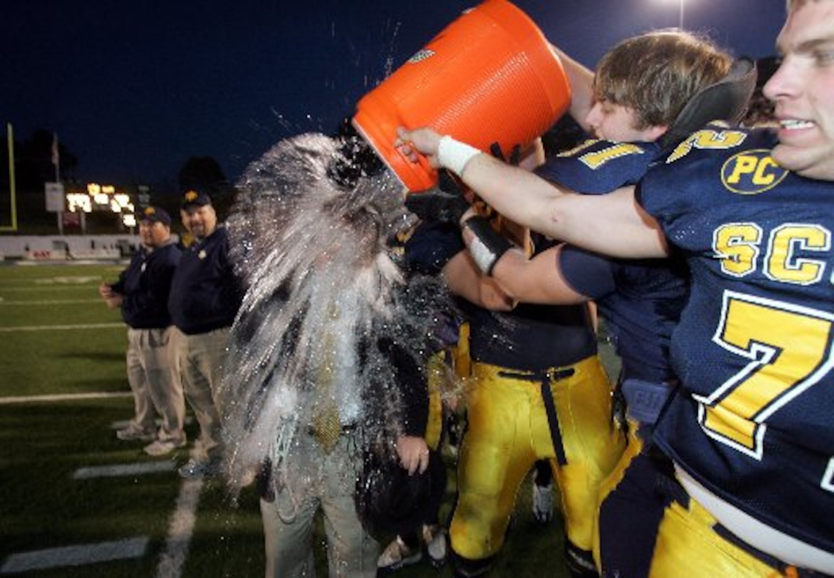 Highland Park coach Randy Allen gets dunked with gatorade after the Scots 59-0 victory in...