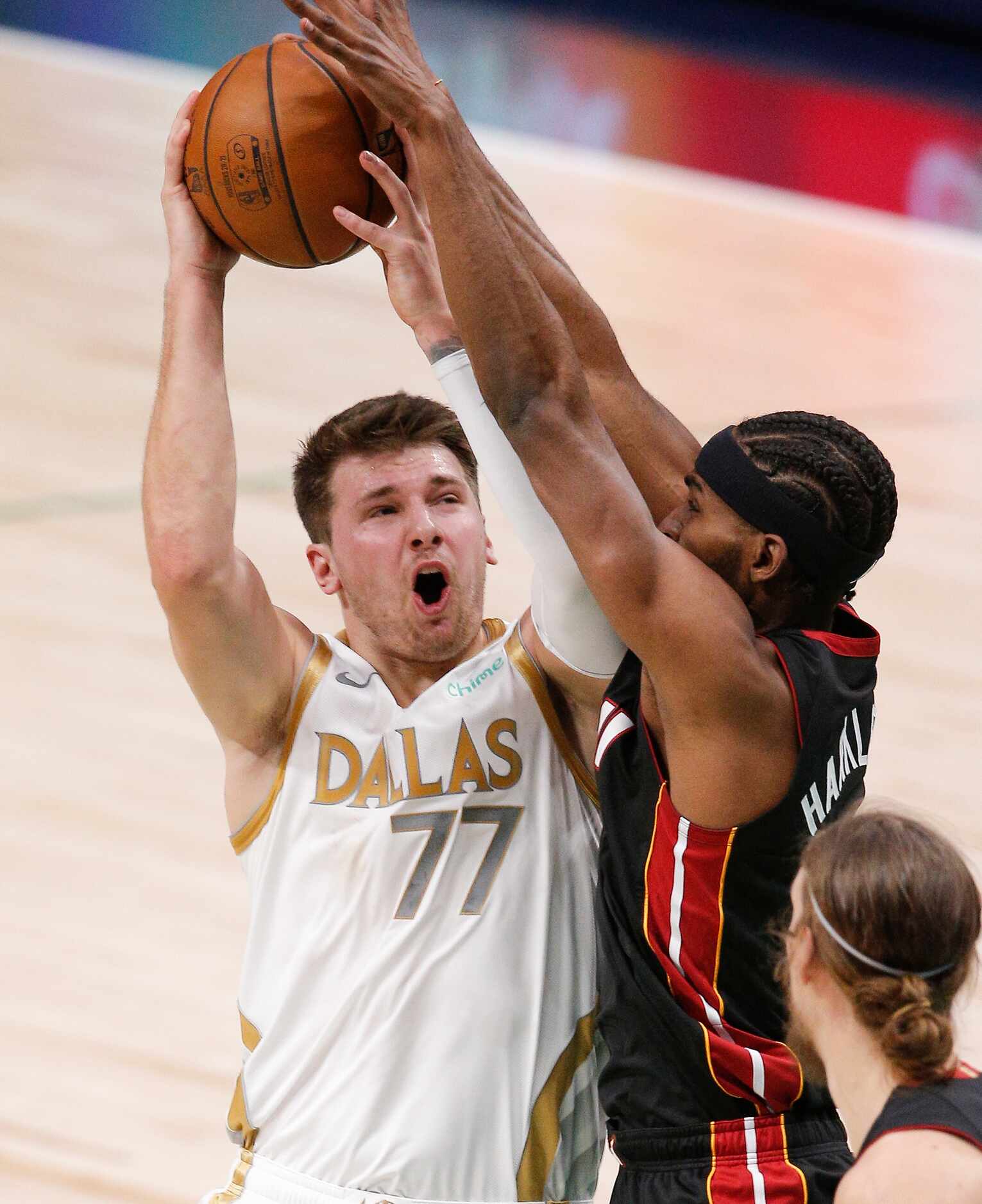 Dallas Mavericks guard Luka Doncic (77) attempts a shot as Miami Heat forward Maurice...