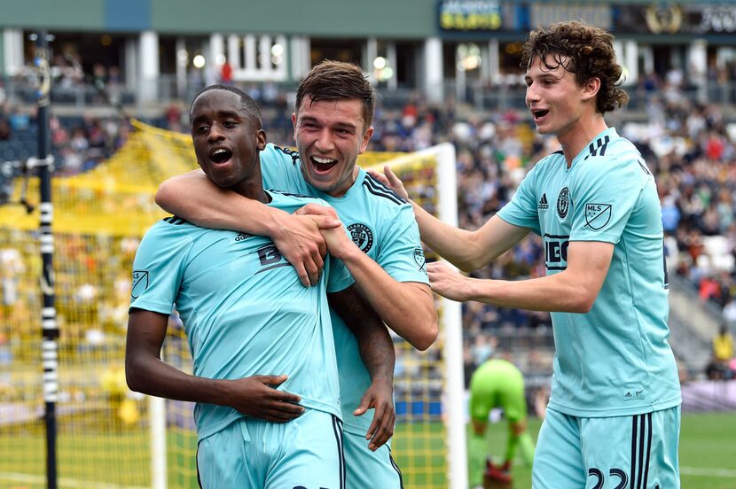 Philadelphia Union's Jamiro Monteiro, left, is congratulated by Kai Wagner, center, and...