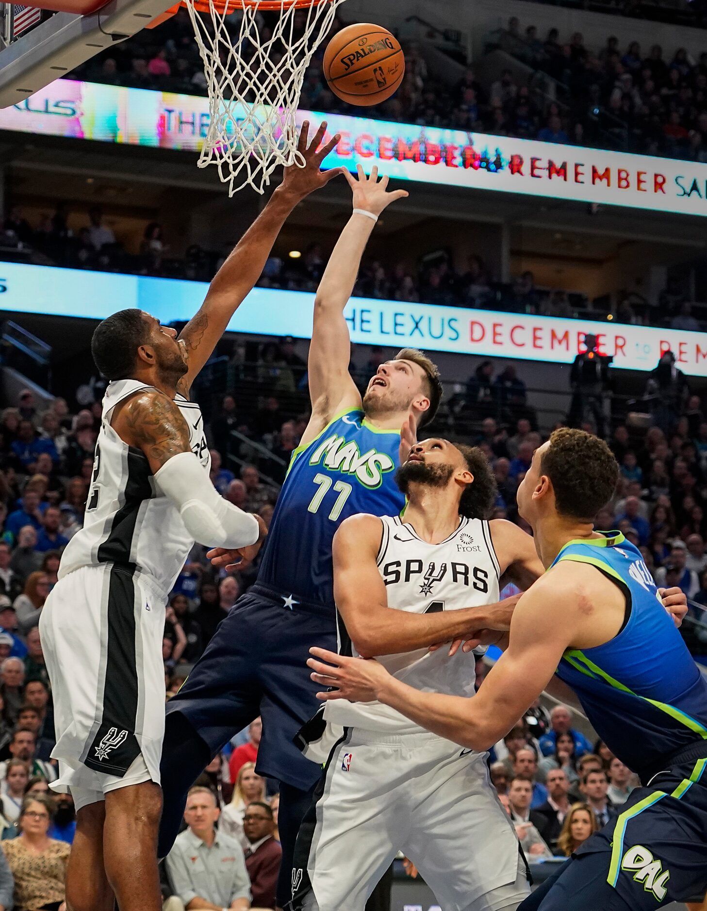 Dallas Mavericks guard Luka Doncic (77) shoots over San Antonio Spurs center LaMarcus...