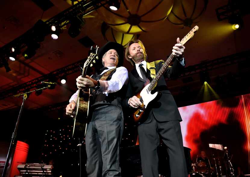Musicians Kix Brooks (L) and Ronnie Dunn of Brooks & Dunn perform onstage during Muhammad...