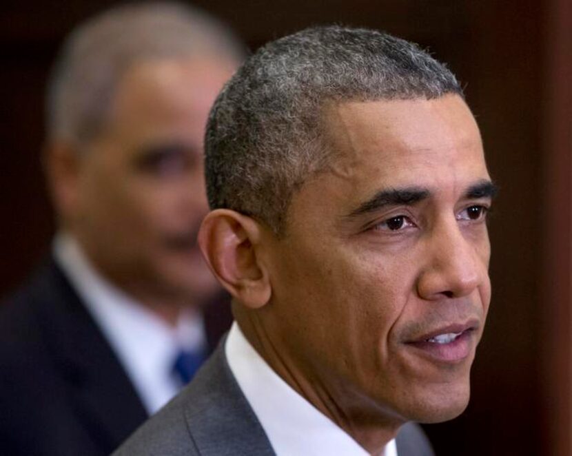 
President Barack Obama, joined by outgoing Attorney General Eric Holder, thanked James...