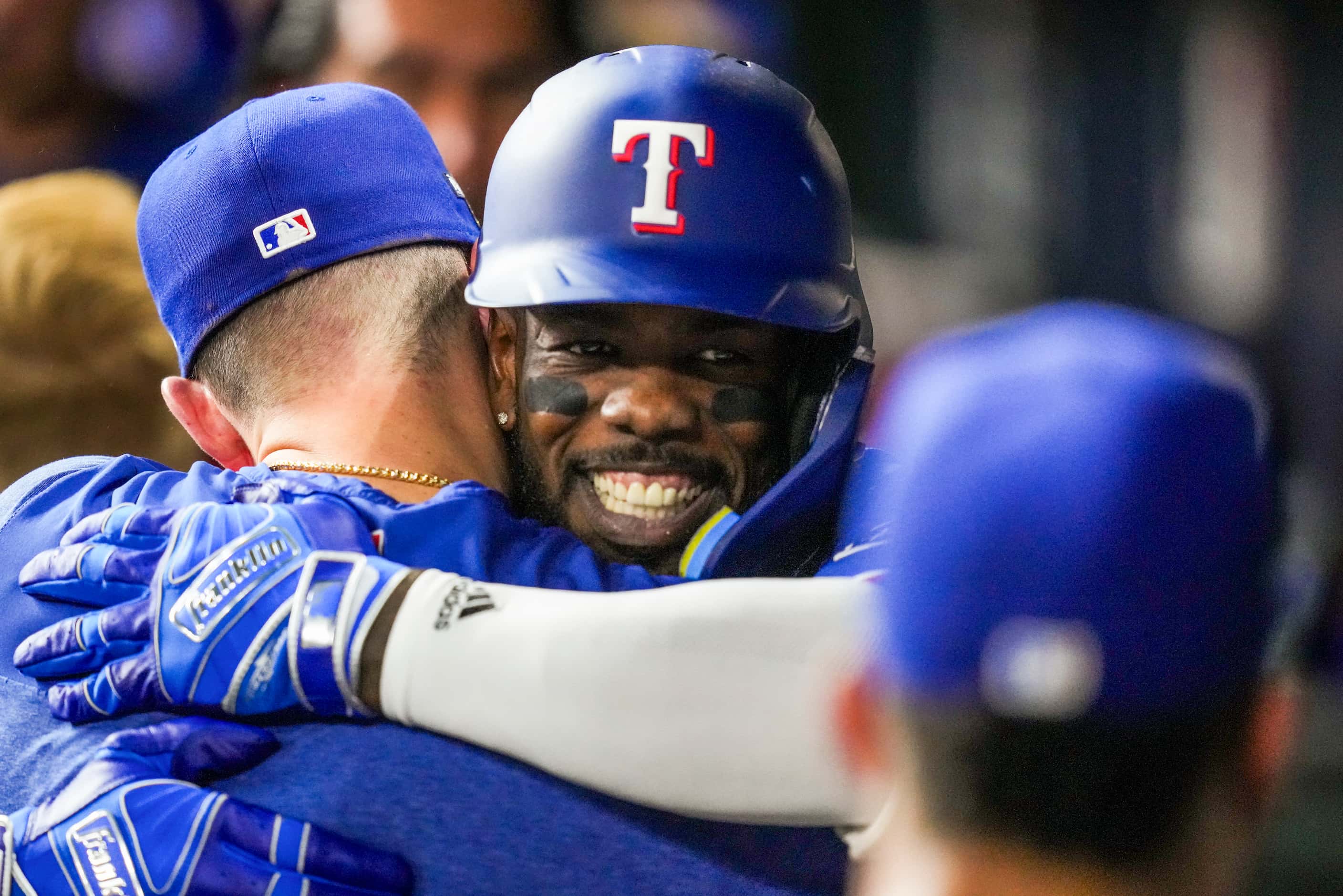 Texas Rangers right fielder Adolis Garcia celebrates with teammates after hitting a grand...