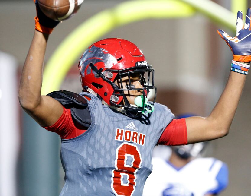 Mesquite Horn High Reggie Roberson (8) signals his touchdown catch during the first half of...