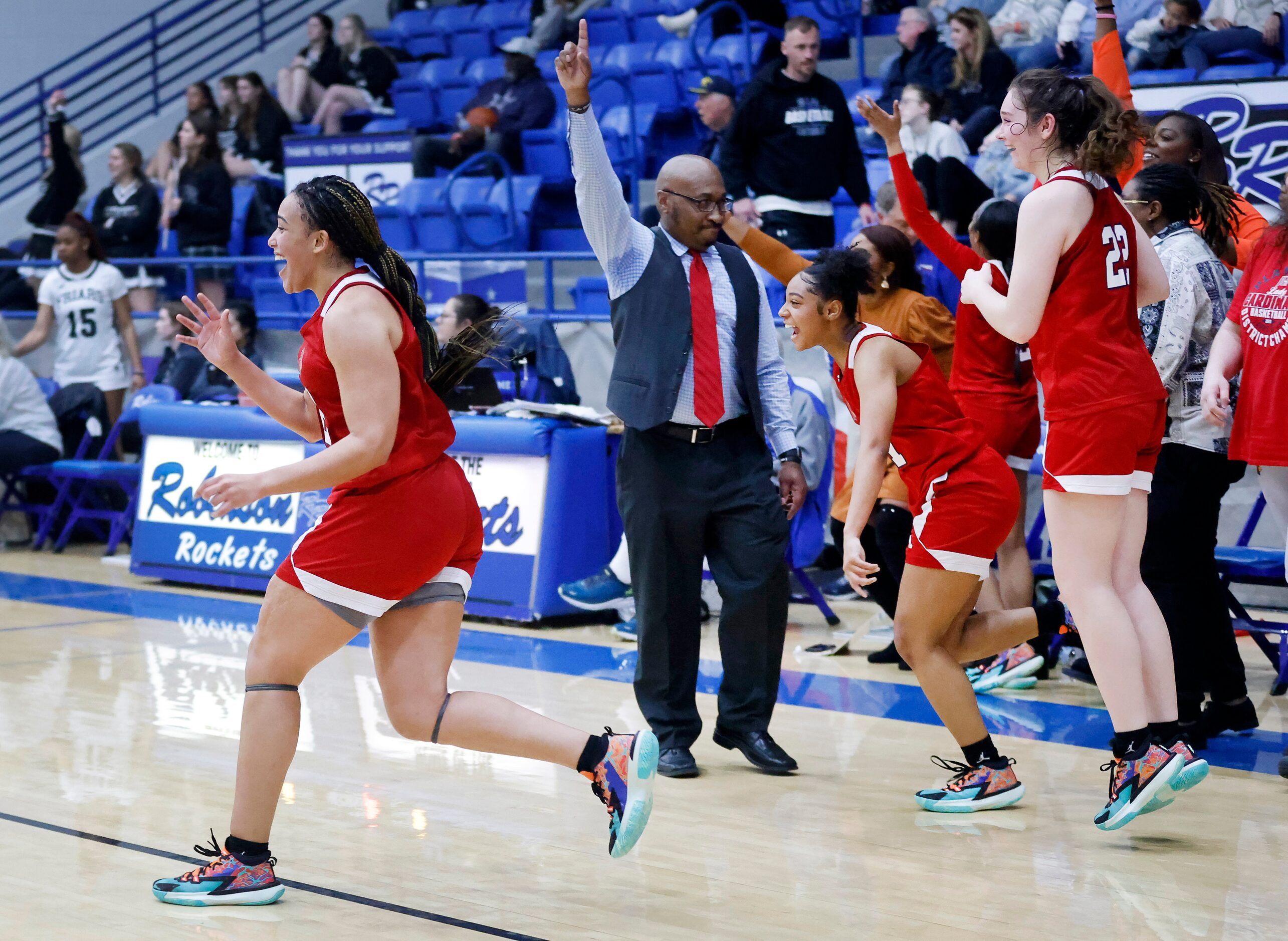 John Paul II forward Allysia McDaniel (32), head coach John Griffin and the rest of the team...