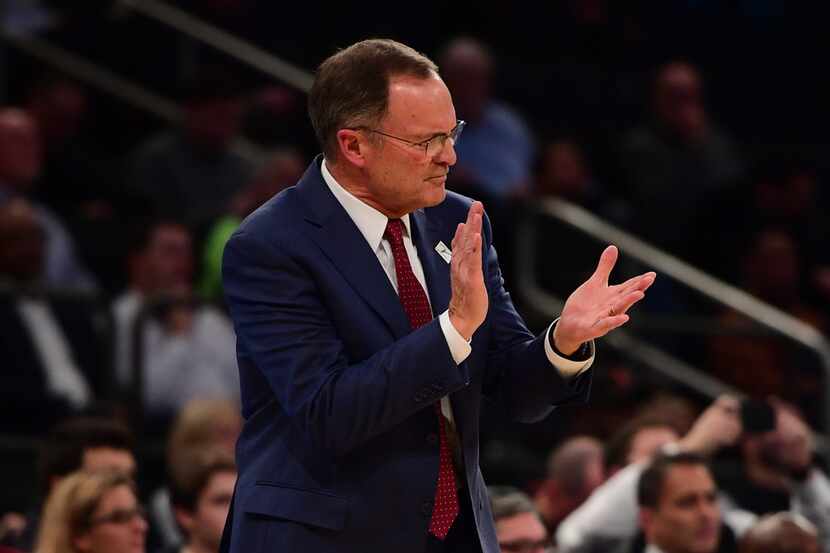NEW YORK, NEW YORK - DECEMBER 04: Oklahoma Sooners head coach Lon Kruger claps during the...