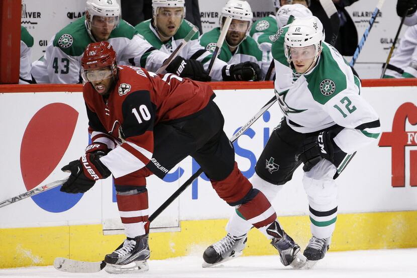 Arizona Coyotes' Anthony Duclair (10) and Dallas Stars' Radek Faksa (12), of the Czech...