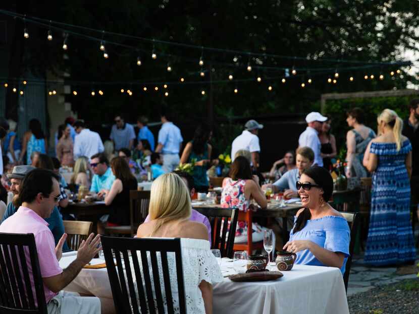 Guests dine outdoors during a supper club dinner at Magdalena's  in Fort Worth.