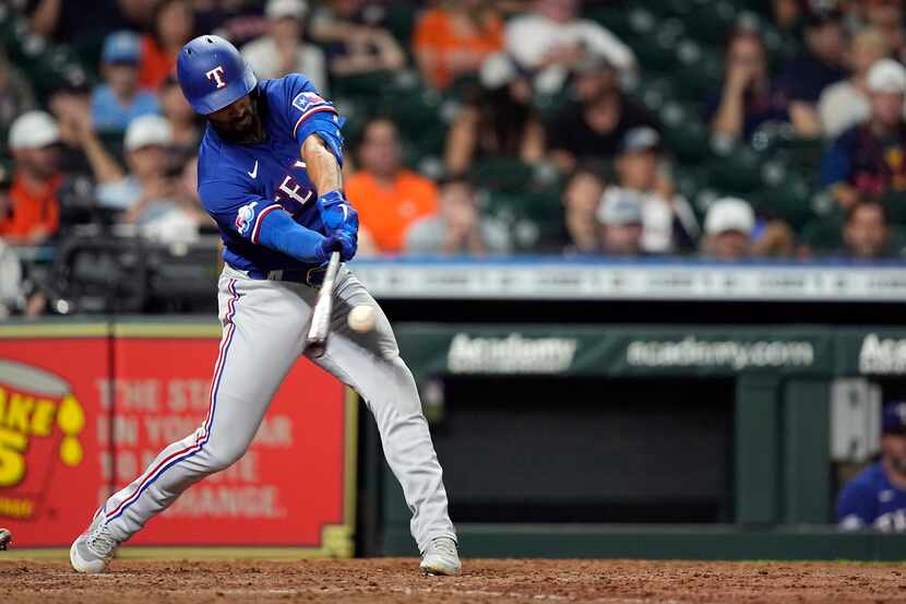 Texas Rangers' Marcus Semien hits a sacrifice fly to score Ezequiel Duran during the 10th...