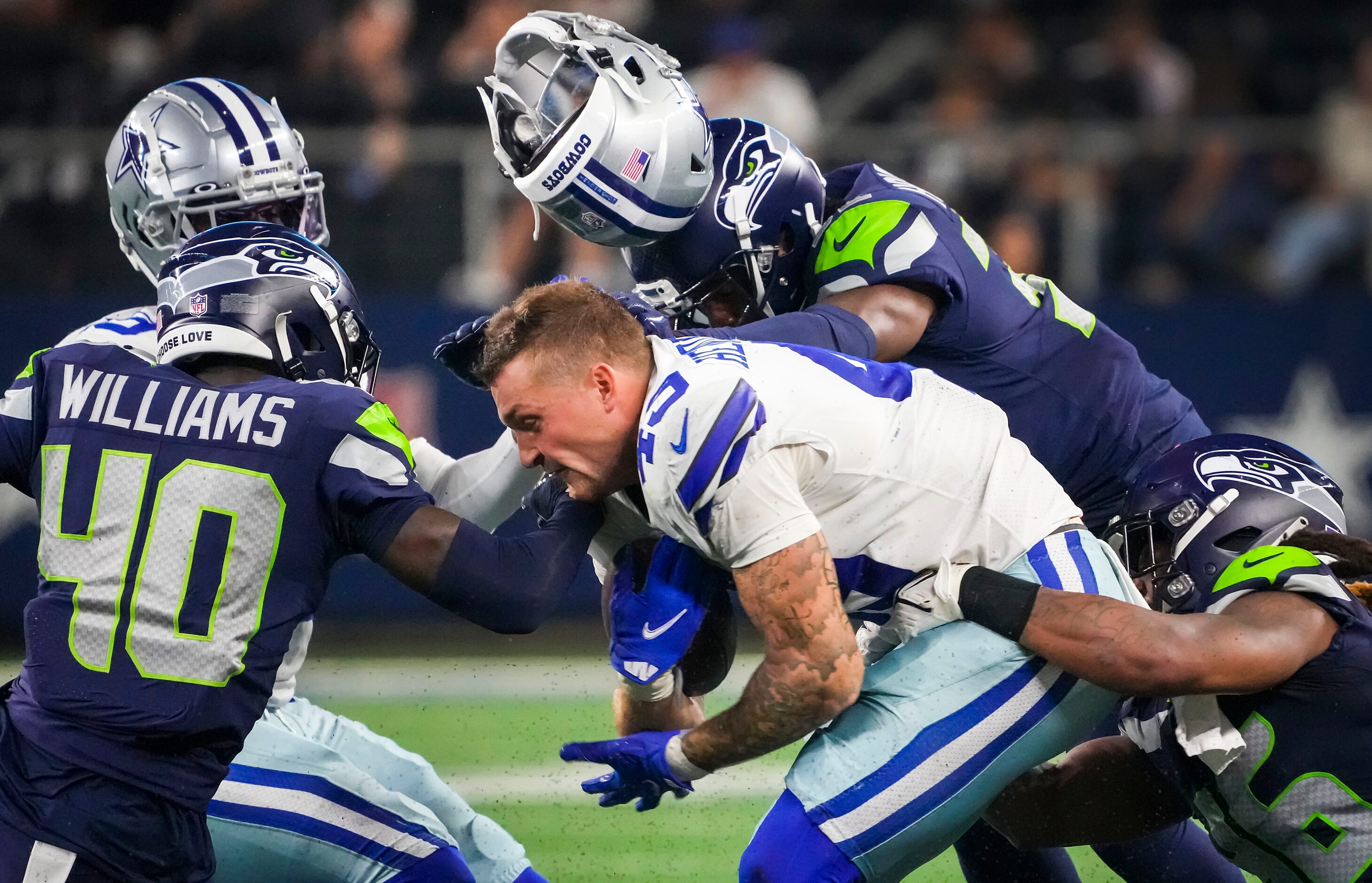 Dallas Cowboys tight end Peyton Hendershot (49) has his helmet knocked off on a hit by...