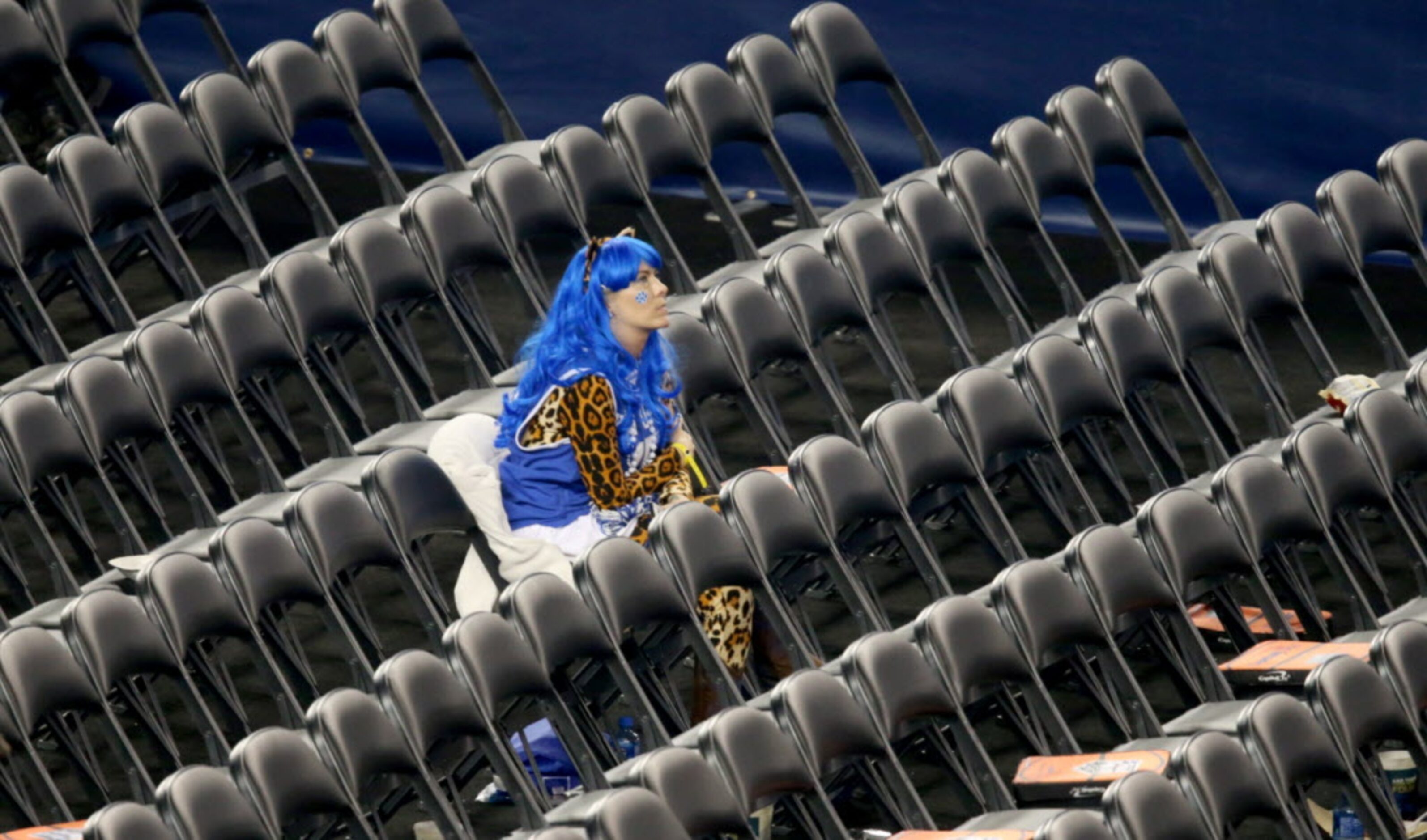 A Kentucky fan sits alone in the student section after loosing against the Connecticut...