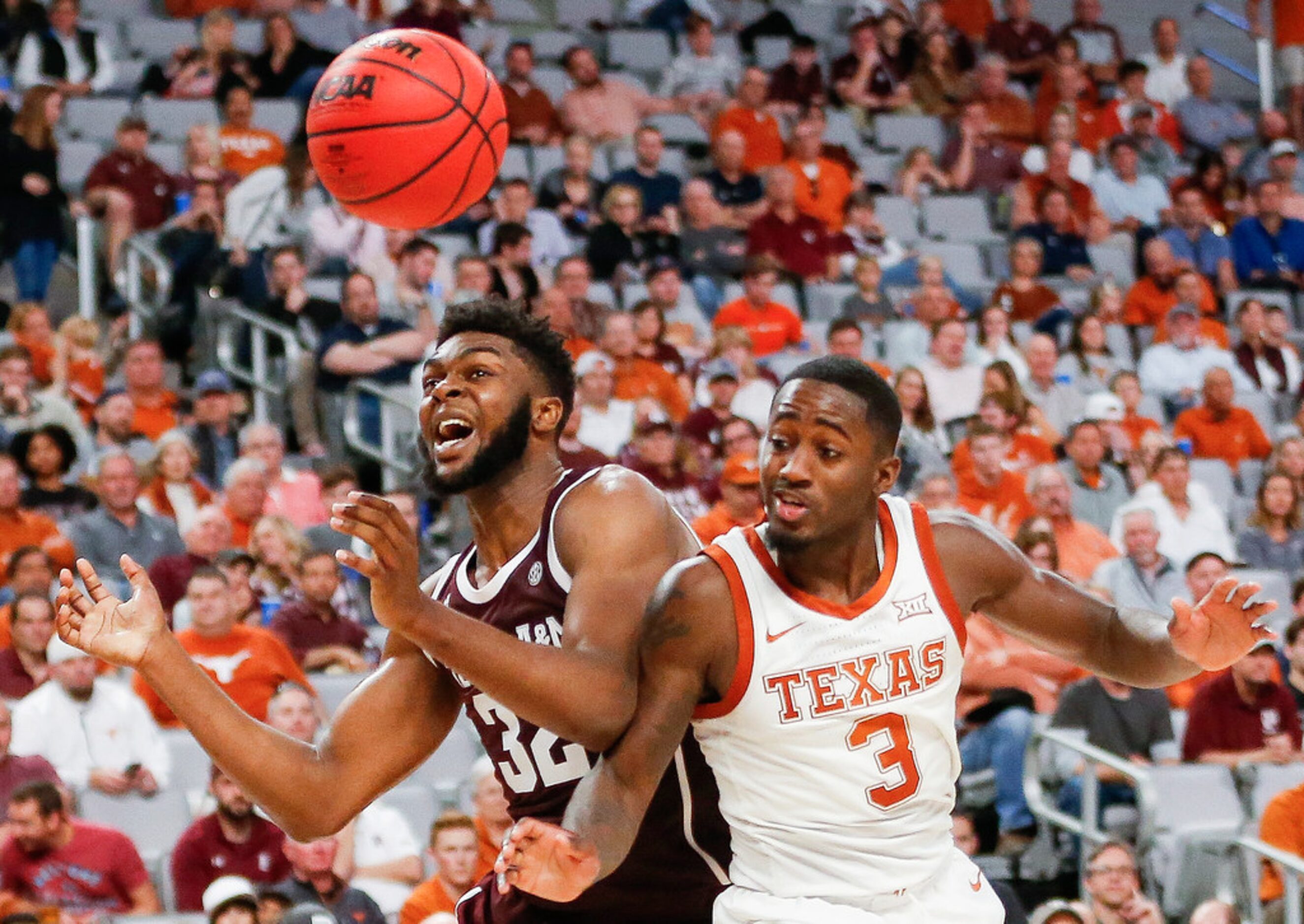 Texas A&M Aggies forward Josh Nebo (32) and Texas Longhorns guard Courtney Ramey (3) battle...