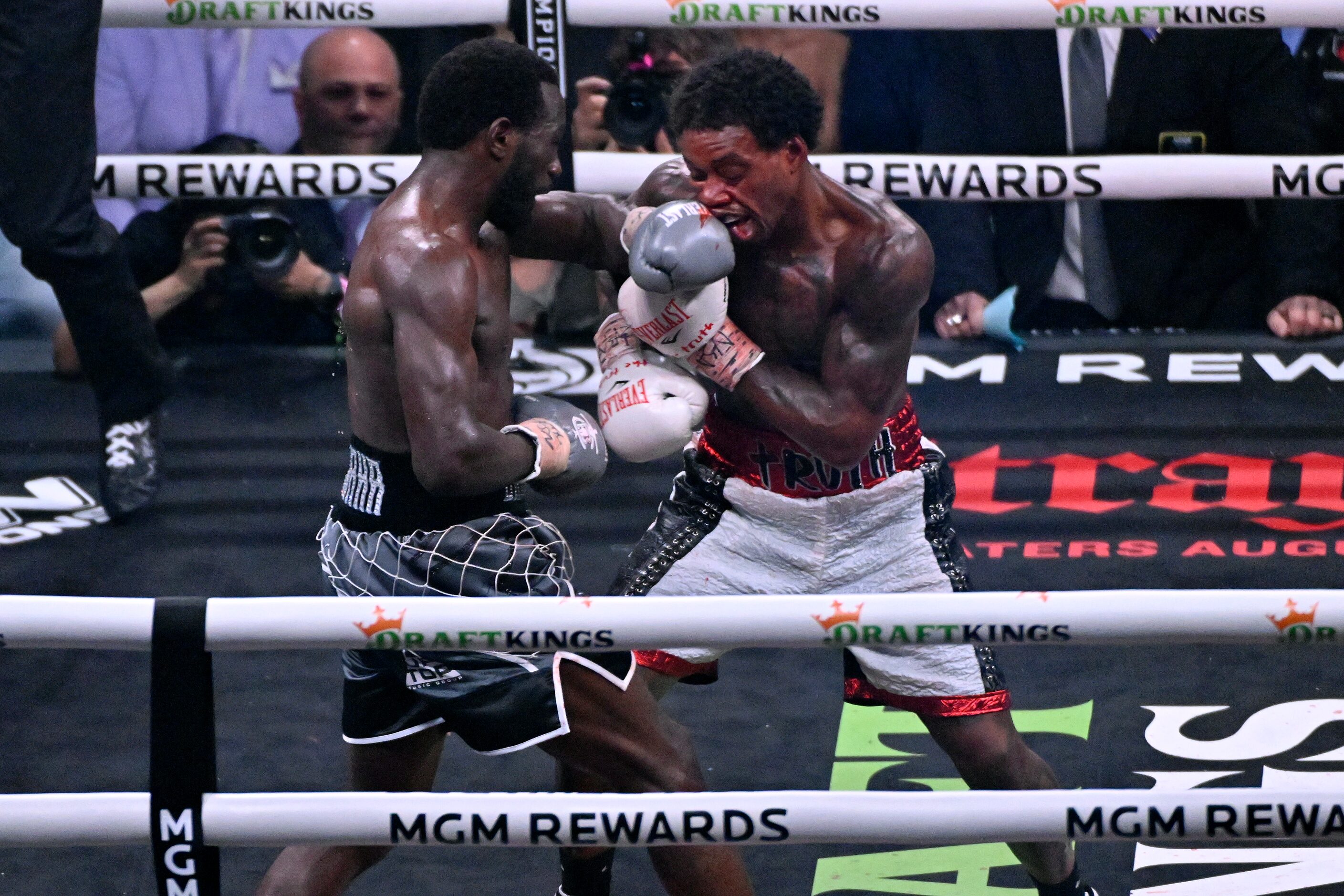 Terence Crawford, left, and Errol Spence Jr. fight during their undisputed welterweight...