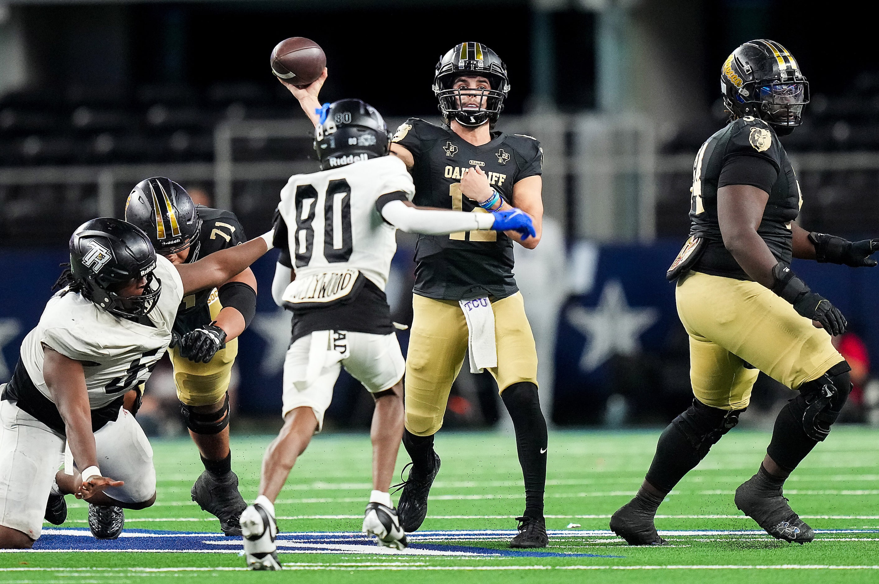 South Oak Cliff quarterback Carter Kopecky (12) completes a pass on a fourth down play...