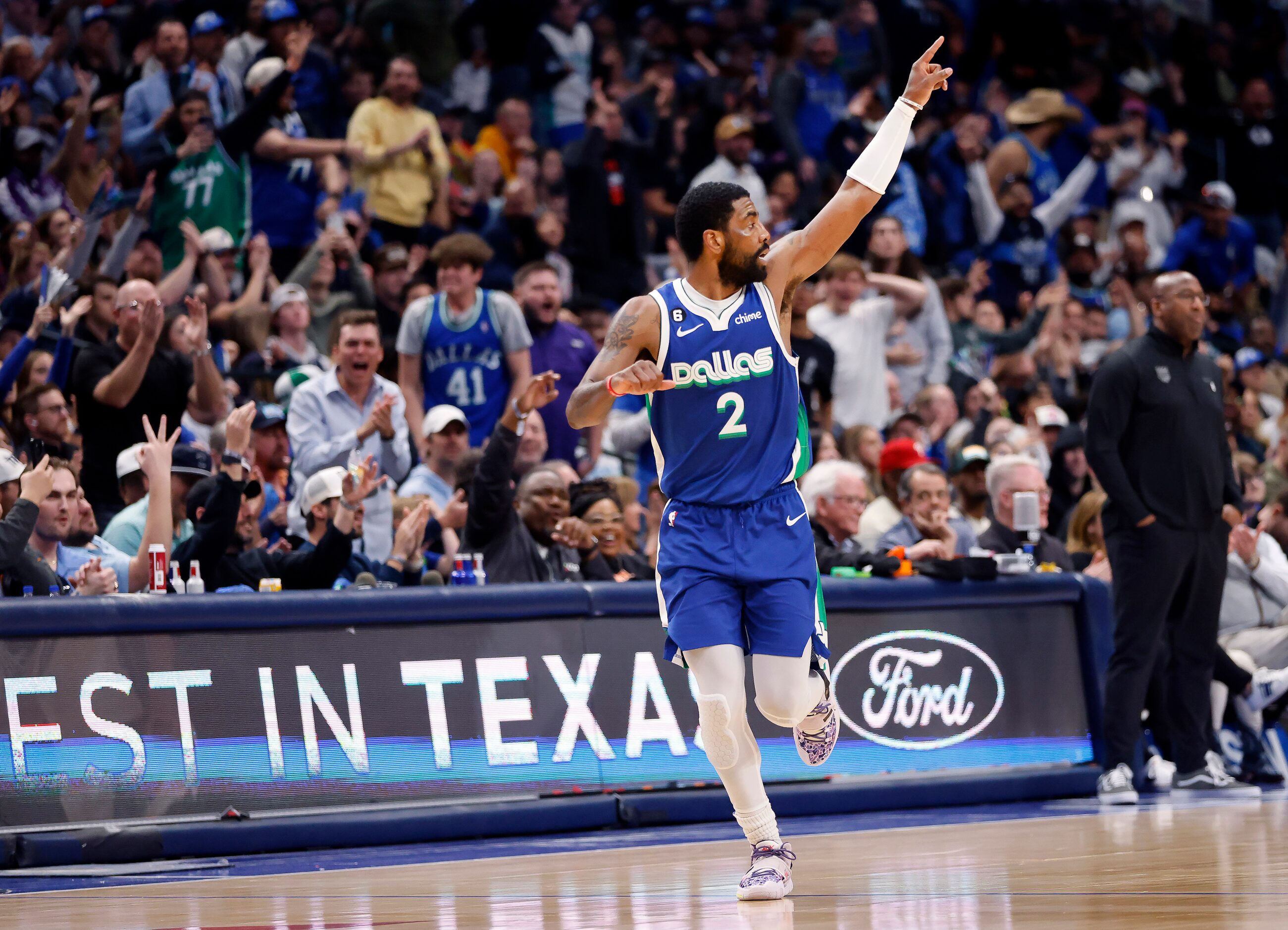 Dallas Mavericks guard Kyrie Irving (2) points to his teammates after hitting a second half...