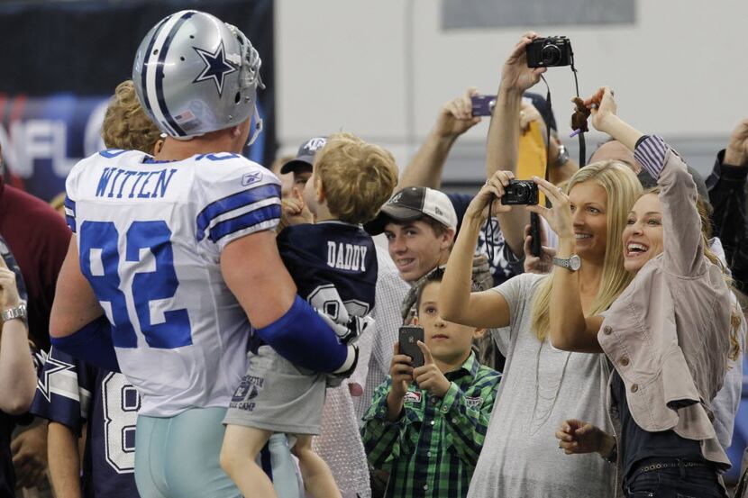 Jason Witten poses for photos with his sons CJ, age four, and Cooper, age two, as his wife...