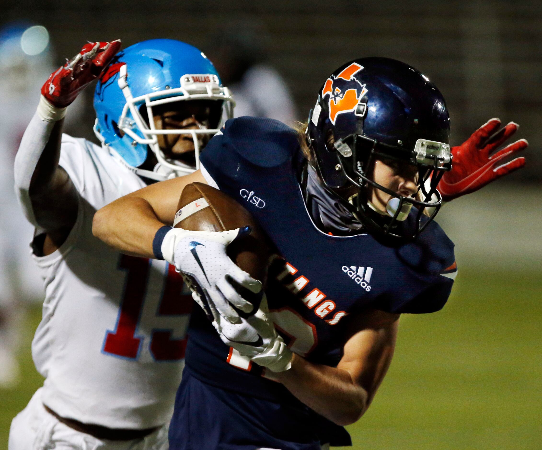 Sachse’s Jagger Roland (12) grabs a pass for a long gain, but is finally stopped by Skyline...