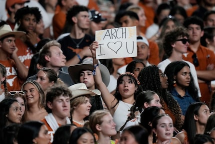 A fans holds a sign for Texas quarterback Arch Manning (16) during the first half of an NCAA...