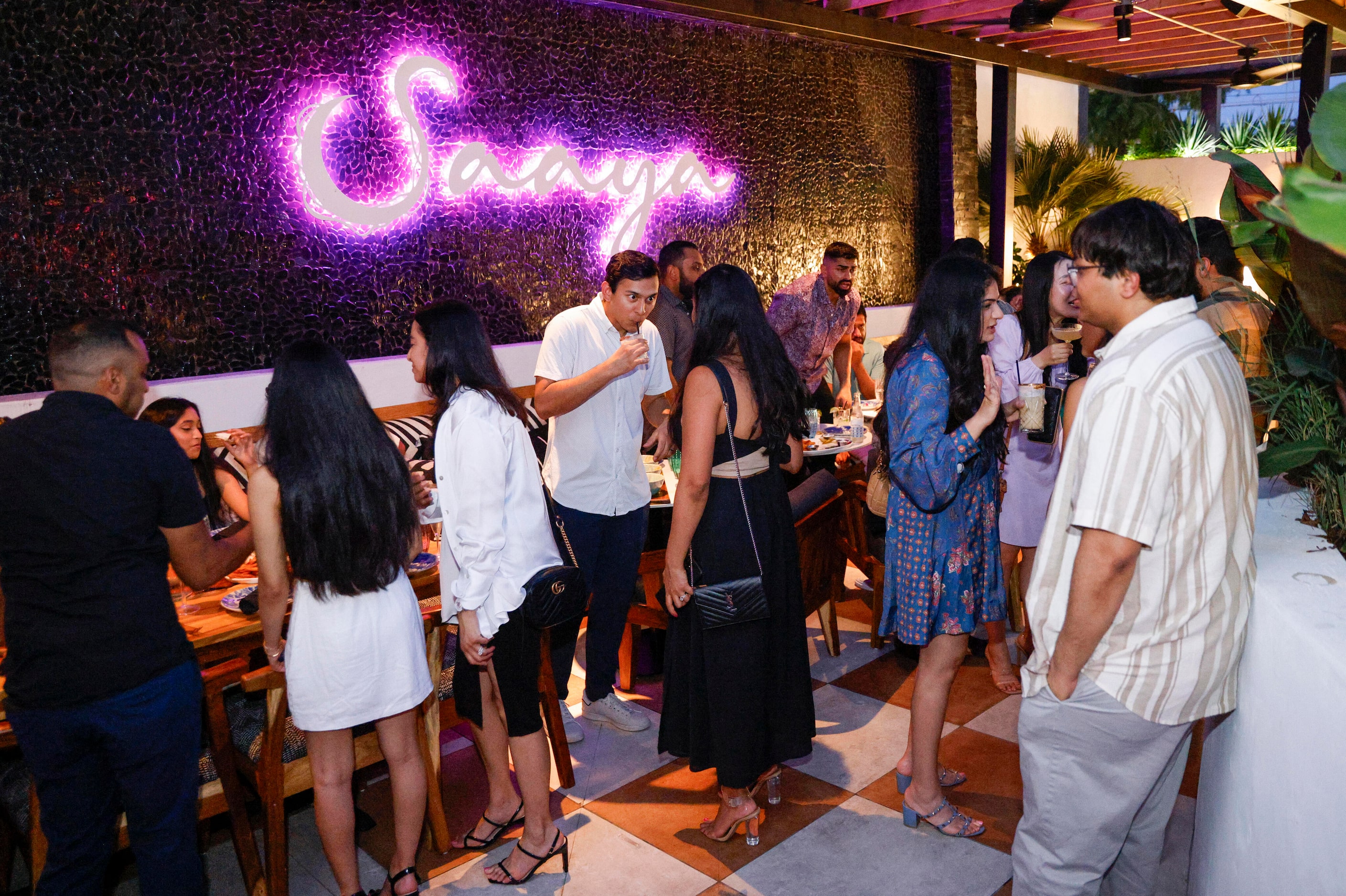 People drink and dine outside at Saaya in Deep Ellum, Saturday, June 17, 2023, in Dallas.