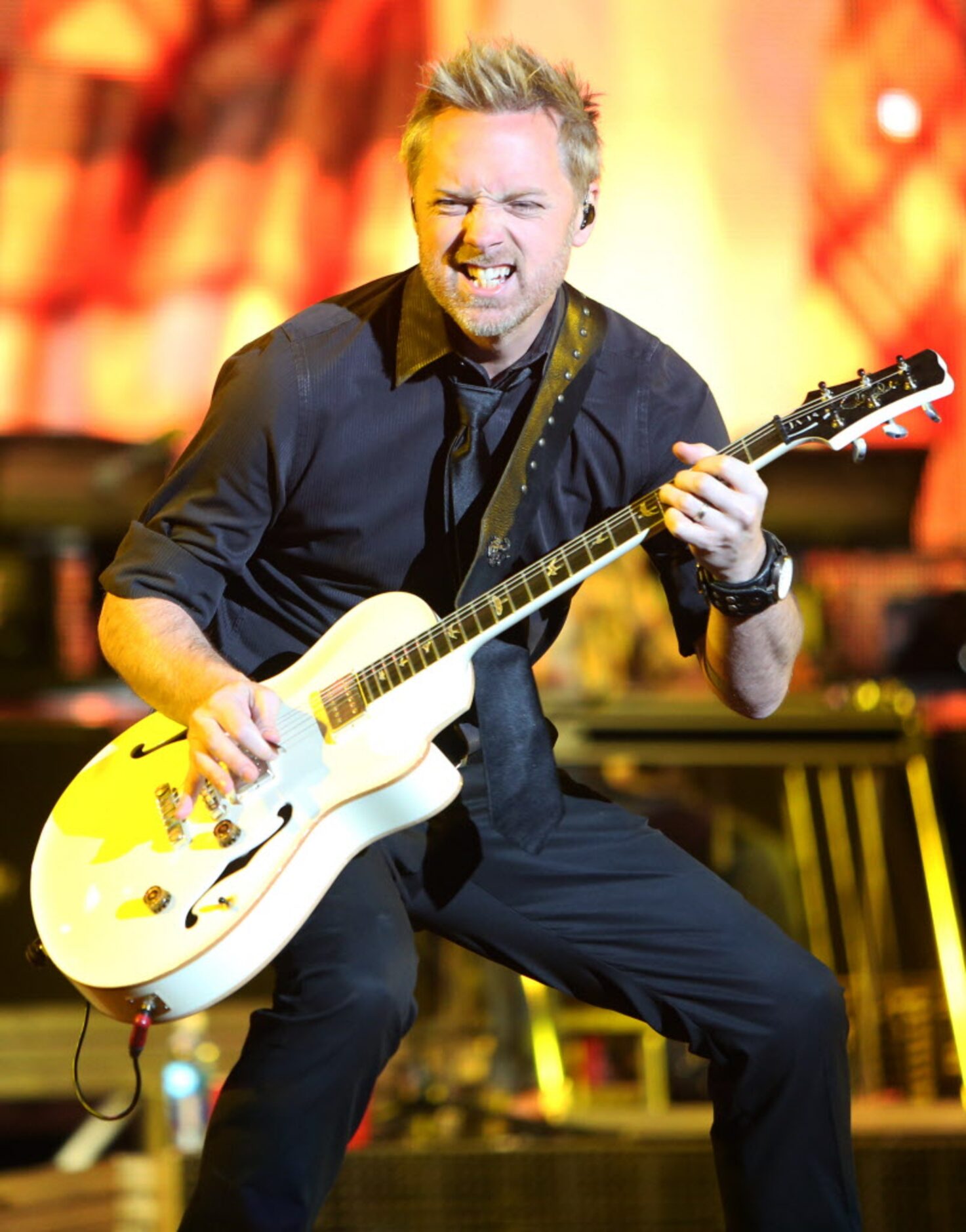 Kurt Allison performs live onstage with Jason Aldean at the 2014 NCAA March Madness Music...