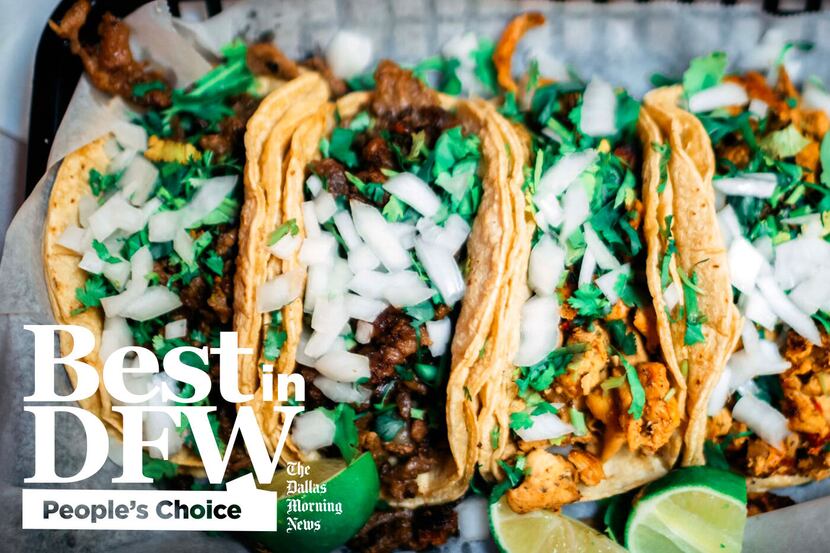 An image of four street-style tacos with chicken and beef topped with onions and cilantro.