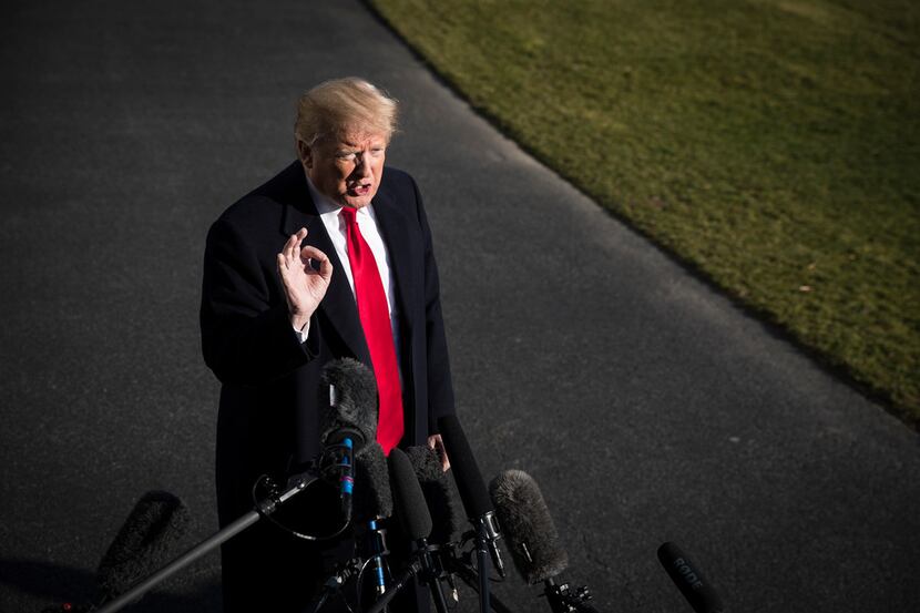 President Donald Trump speaks to reporters after returning to the White House in Washington...