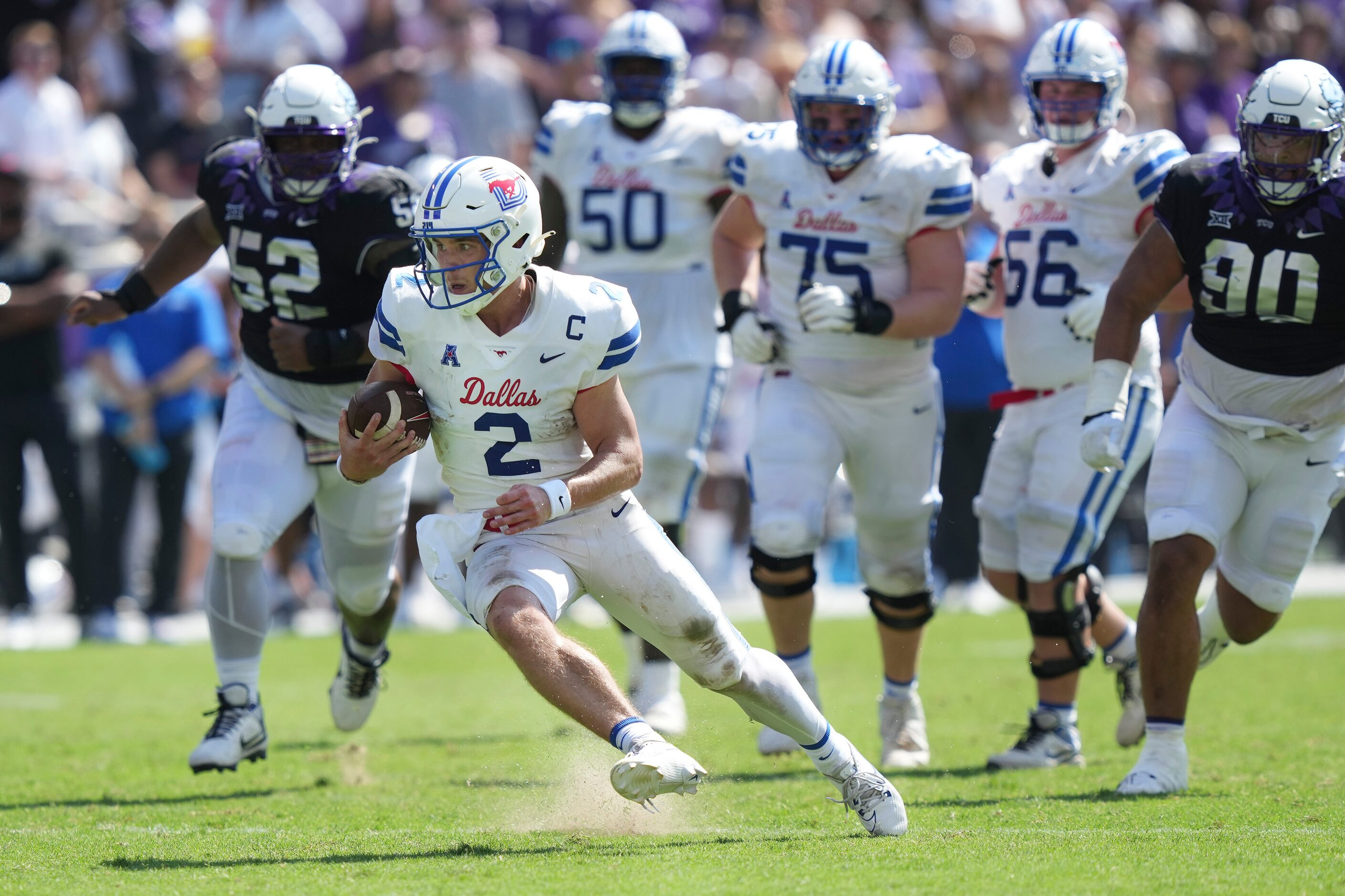 SMU quarterback Preston Stone (2) runs on a keeper during the first half of an NCAA college...