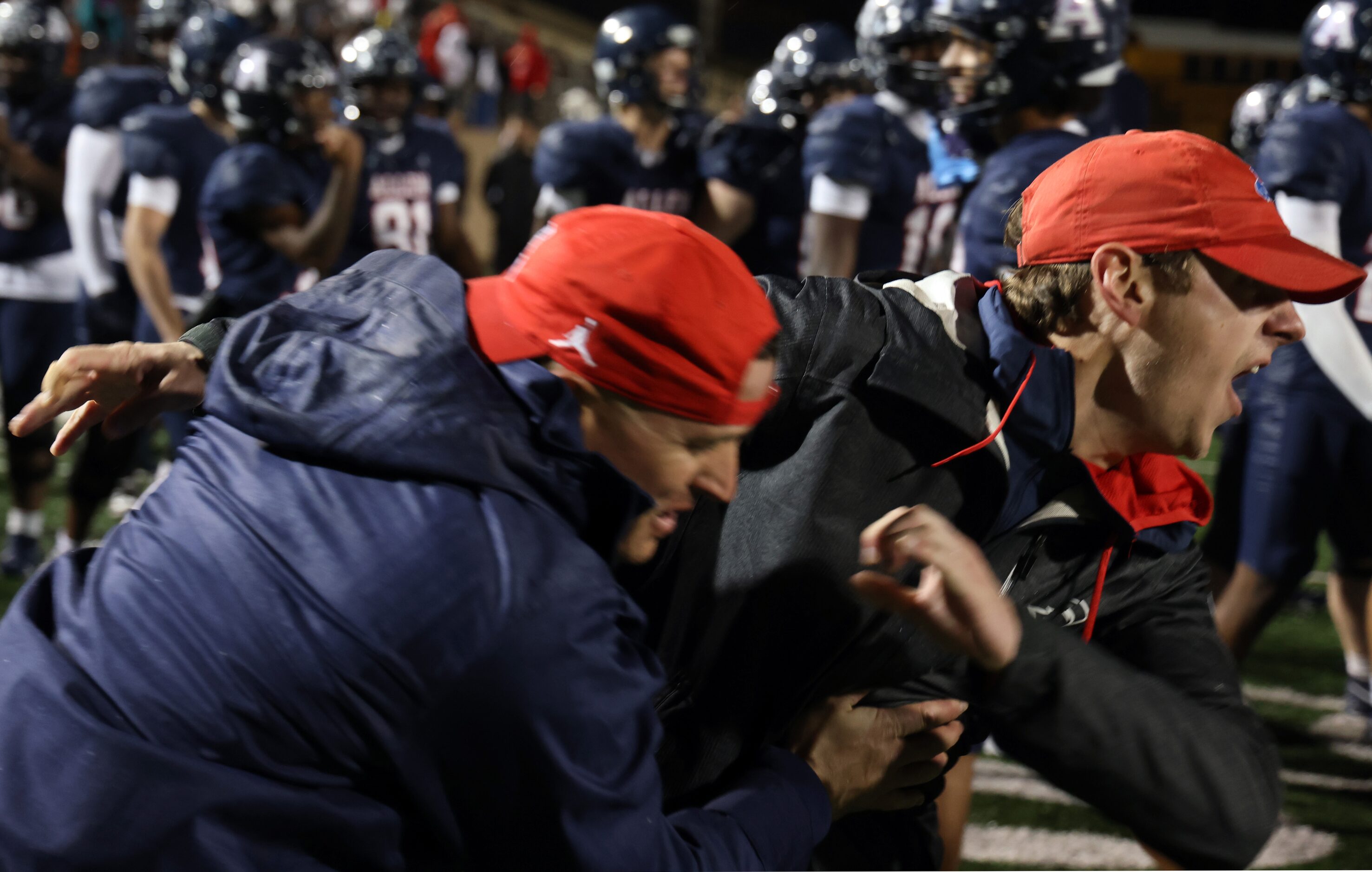 A pair of Allen assistant coaches bolt onto the field to celebrate with Eagles players...