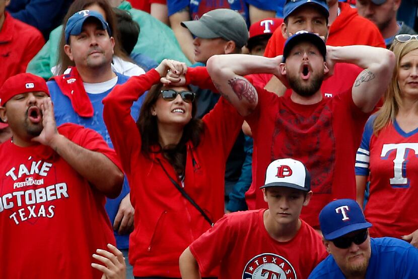 Texas Rangers fans reacts to a call against the Rangers during the 8th inning against...