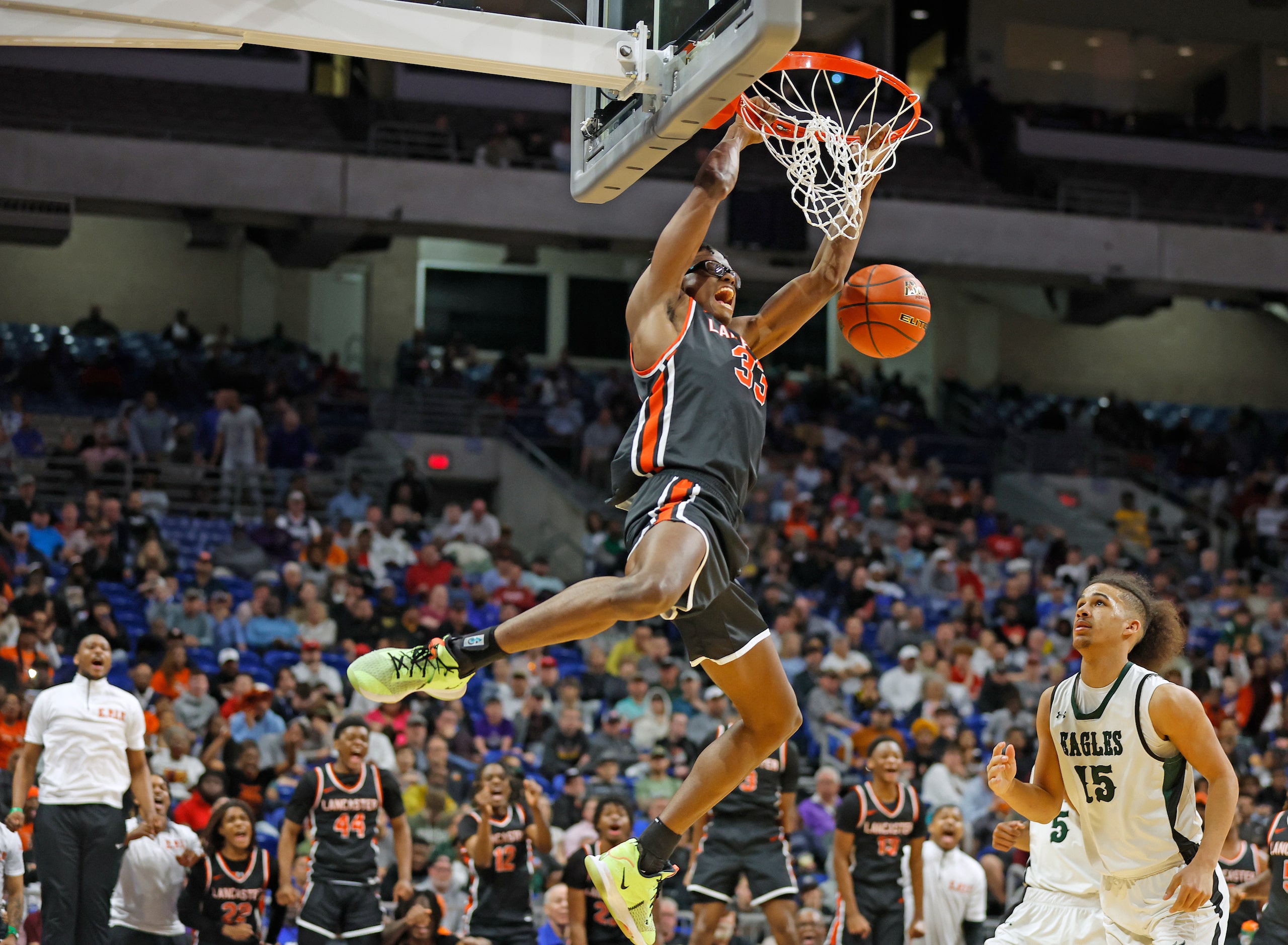 Lancaster's Amari Reed (33) dunks while Killeen Ellison's Marneko Thomas (15) defends in the...