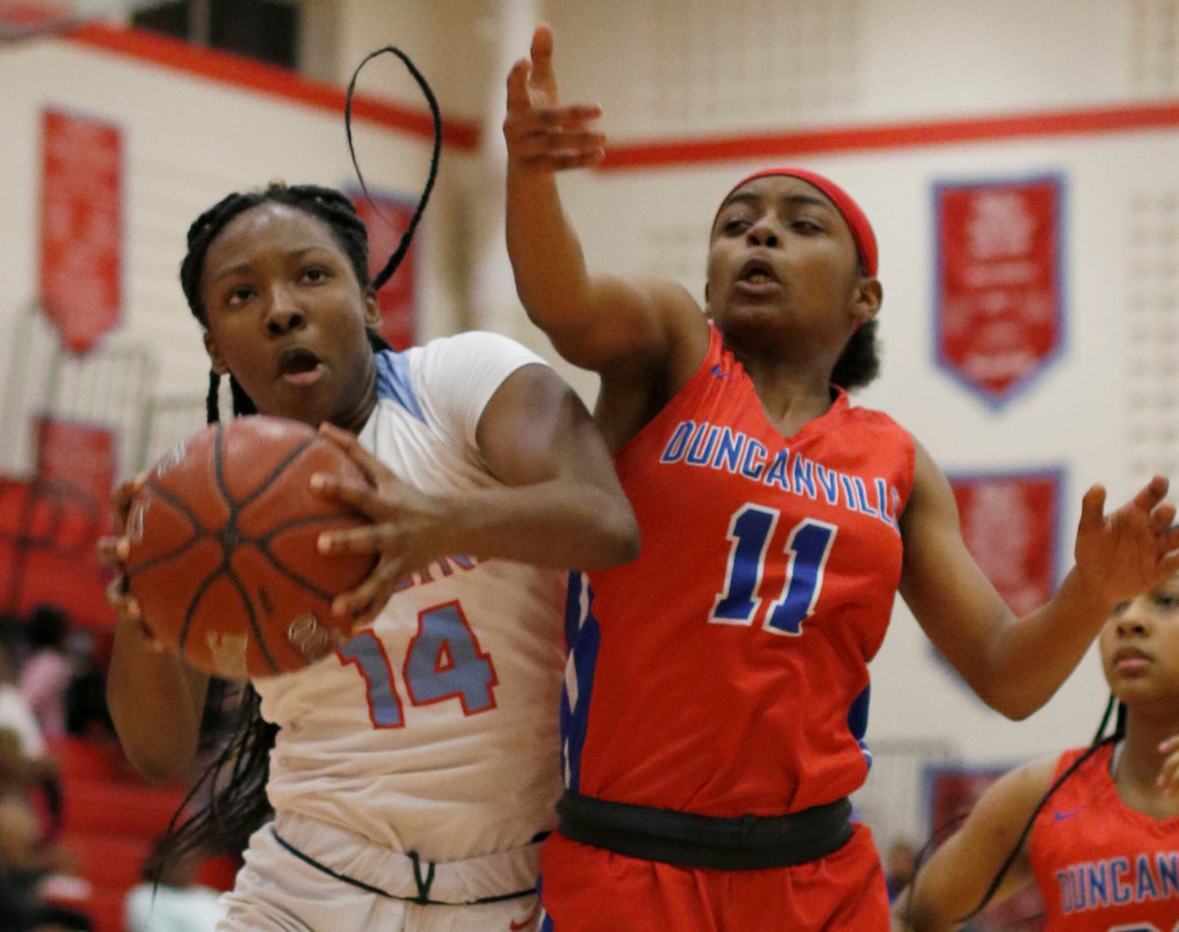 Dallas Skyline's Daryn Batts (14) pulls down a defensive rebound as she is challenged by...