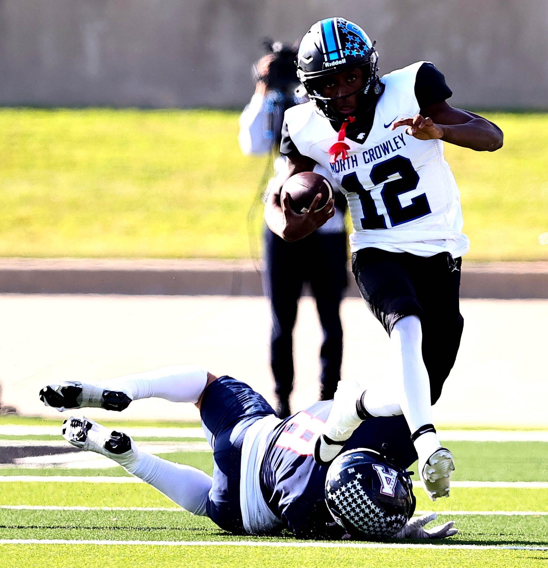 North Crowley quarterback Chris Jimerson Jr (12) breaks a tackle from Allen linebacker Drew...