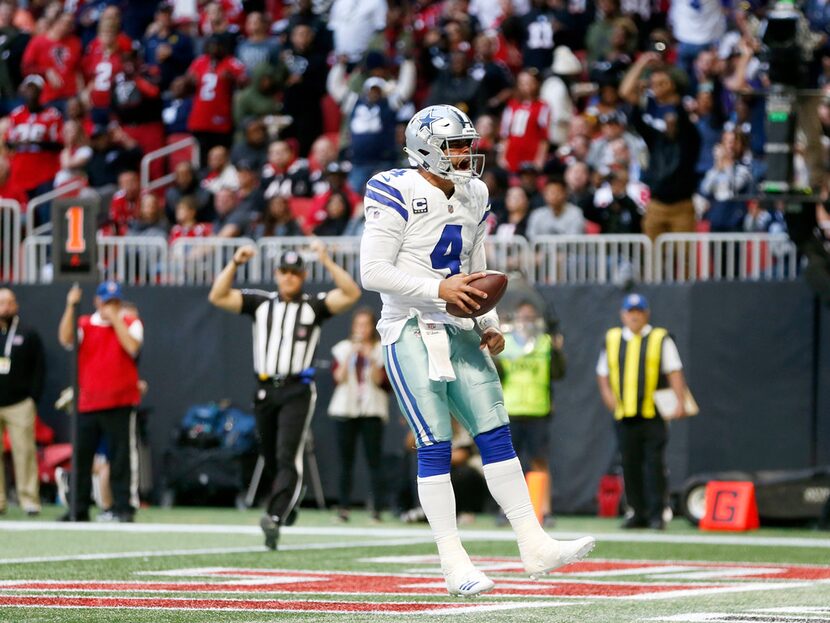 Dallas Cowboys quarterback Dak Prescott (4) celebrates after scoring a touchdown during the...