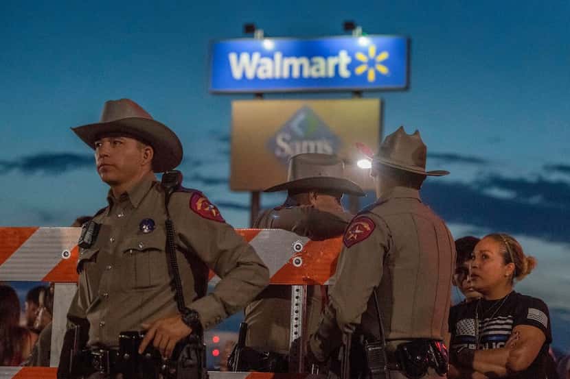 Texas State Troopers keep watch at the makeshift memorial for victims of the shooting that...