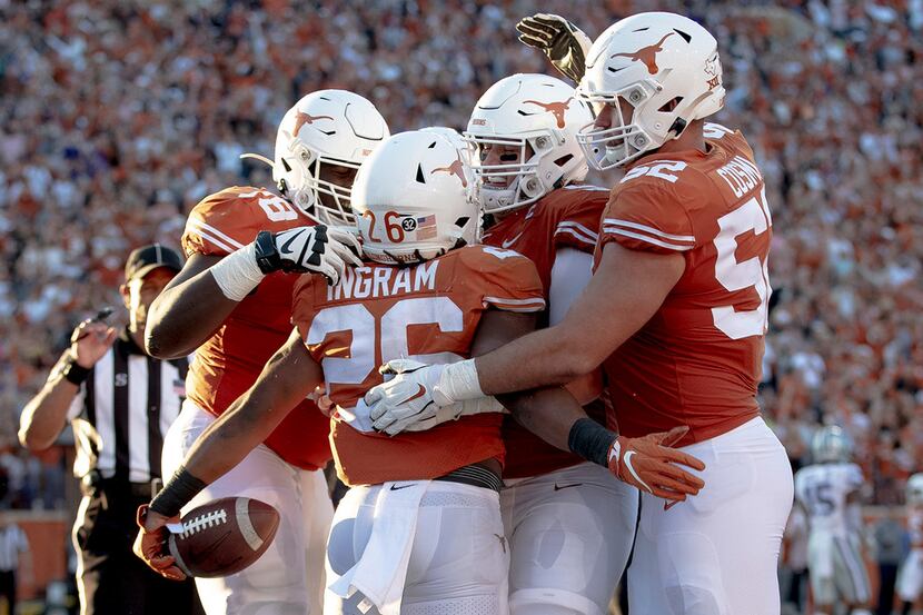 Texas running back Keaontay Ingram (26) celebrates a touchdown with teammates during the...