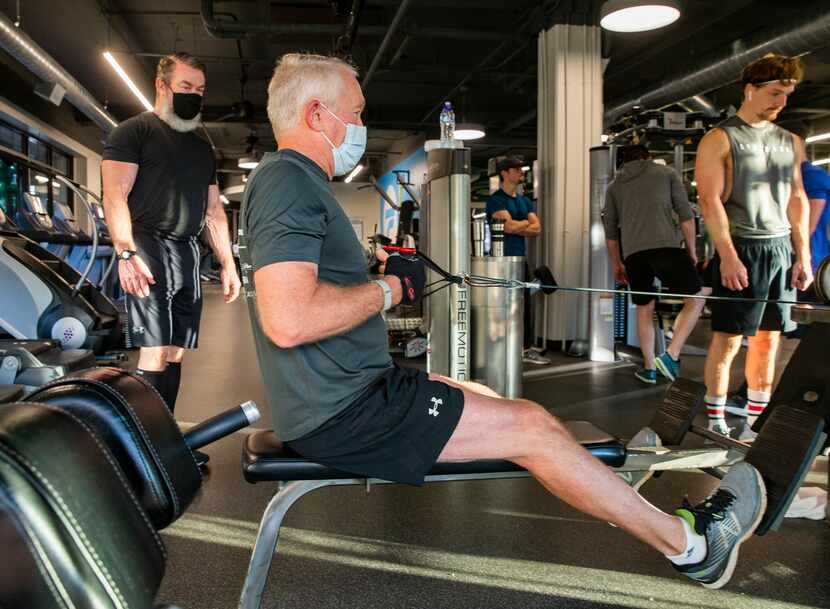 Client Durward Watson of Oak Lawn (center) works out with Trophy Fitness trainer John Gordon...