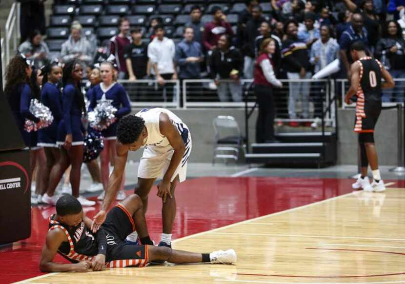 Frisco Lone Star's Marvin Mims (2) reaches to help up Lancaster's Demonte Williams (2)...