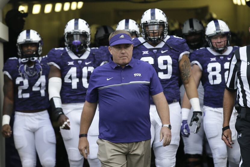 TCU head coach Gary Patterson walks onto the field with is players before an NCAA college...