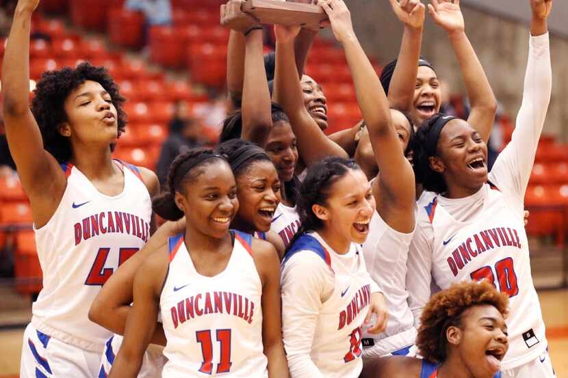 Duncanville's girls basketball team celebrate their 62-49 win over South Grand Prairie in...