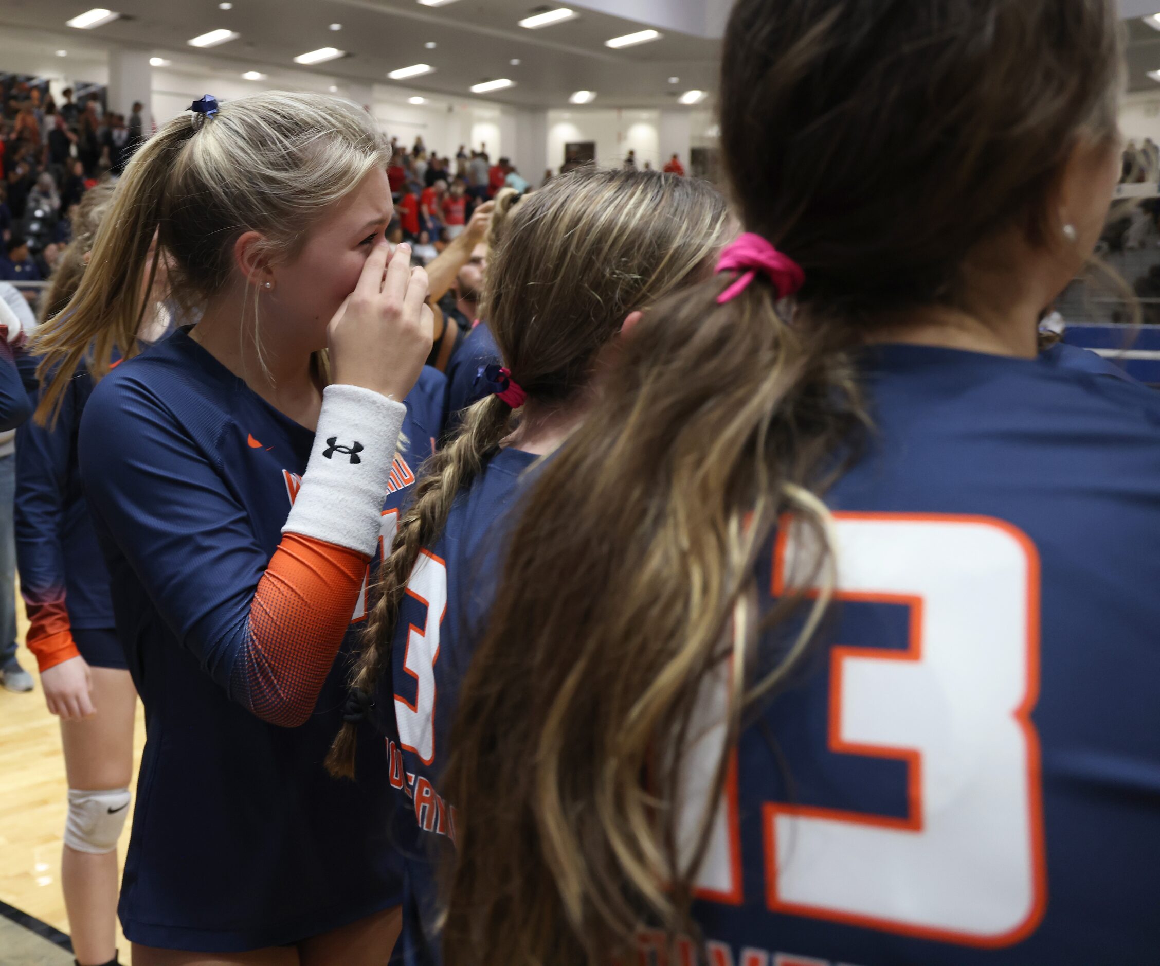 Frisco Wakeland's Bella Wood (11), left, becomes emotional as she celebrates with teammates...