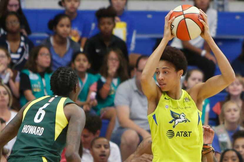 Dallas Wings forward Isabelle Harrison (20) pulls down a defensive rebound as Seattle Storm...