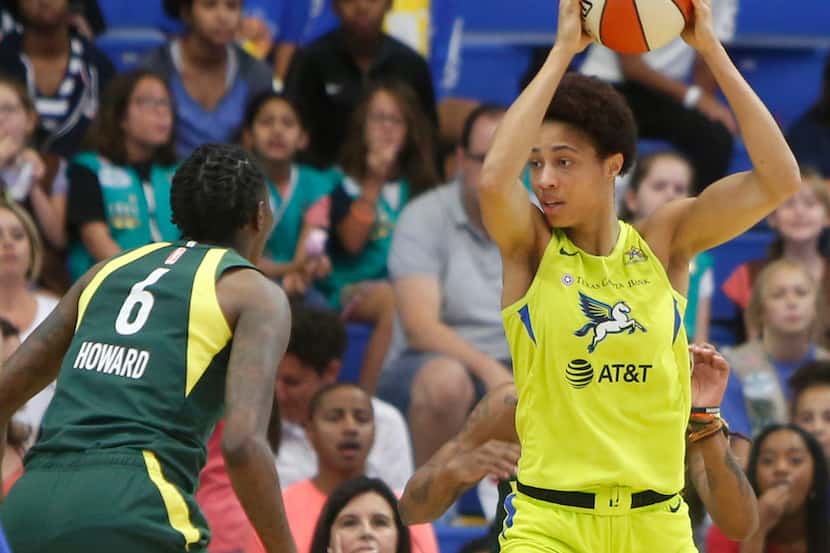 Dallas Wings forward Isabelle Harrison (20) pulls down a defensive rebound as Seattle Storm...