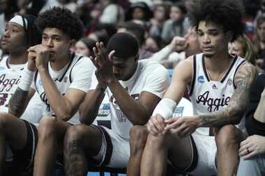 The Texas A&M bench reacts during the second half of a first-round college basketball game...