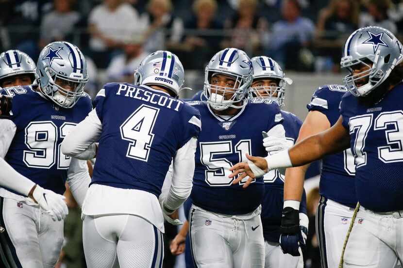 Dallas Cowboys quarterback Dak Prescott (4) welcomes the team onto the field for warmups...