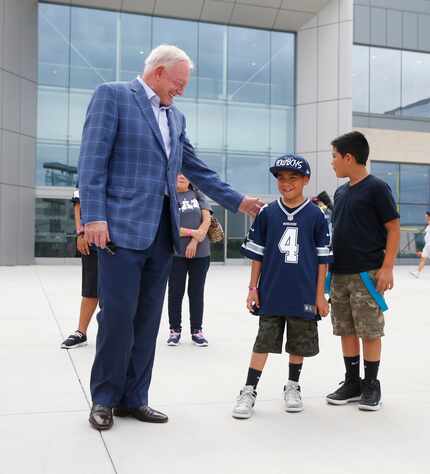 Dallas Cowboys owner Jerry Jones greets RayRay Melgarejo, 9, with Make-Wish-Foundation and...