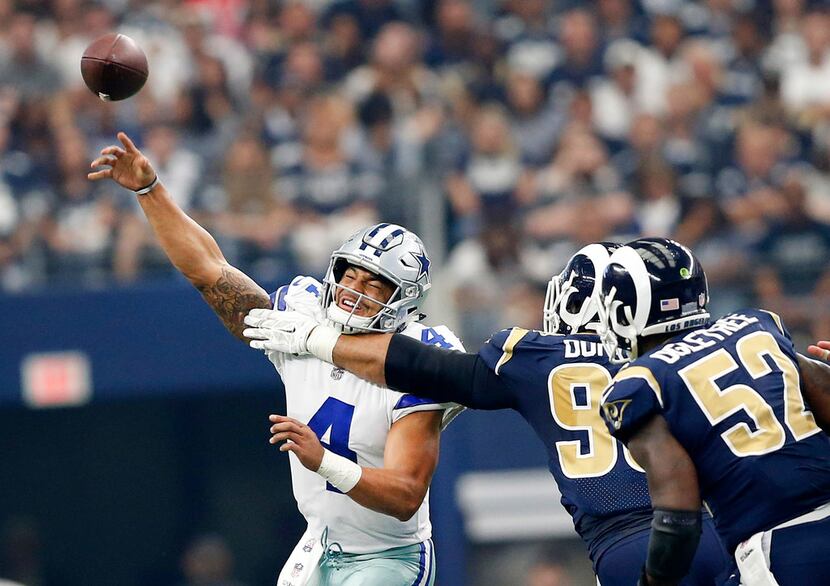 Los Angeles Rams defensive end Aaron Donald (99) gets a hand on Dallas Cowboys quarterback...